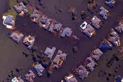NOAA aerial image of New Orleans, La., showing homes destroyed by Hurricane Katrina and a neighborhood inundated by flood waters.