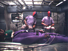 Crash test dummies inside ambulance patient compartment.