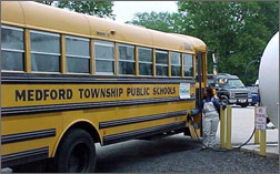 Photo of a school bus fueling with biodiesel.