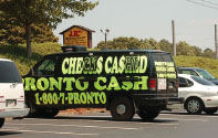 Cash and evidence seized during an investigation into the illegal activities of Pronto Cash, a Florida business, that used mobile check-cashing vans pictured above, indicted for operating an unlicensed money service.