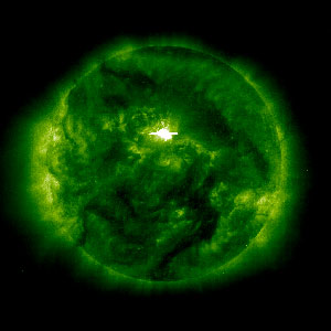 The particles that cause the aurora borealis are energized in the magnetosphere, that is, above the atmosphere.  The color of the light wave, or its wavelength, is determined by the atom in the atmosphere that is excited by the particle. For example, oxygen atoms will emit green light. This green light is typically emitted at altitudes around 100 kilometers. The red light from auroras comes from atoms at higher altitudes, 300-500 kilometers.