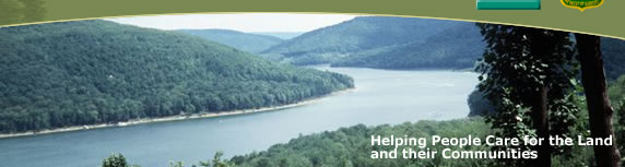  [Photo]:  Photo of a river with forestland.  Text stating Helping People Care for the Land and their Communities is located in bottom right corner.
