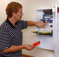 Employee stocking a first aid kit