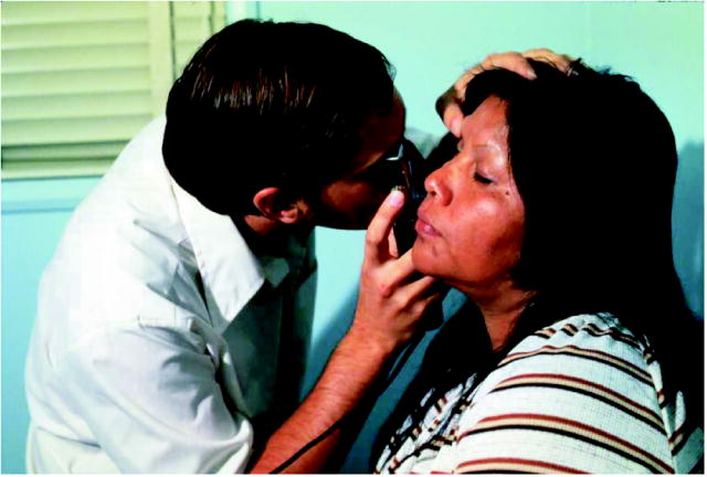 This is a photograph of a physician examining a patient at a Community Health Center.