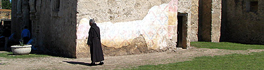 Franciscan walking to the front of the mission church