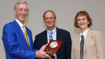Dr. Lee Redinger receives an award from ORISE's Wayne Stevenson and Linda Holmes