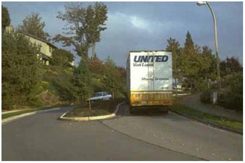 This traffic-calming measure uses a landscaped median to narrow the travel lanes.