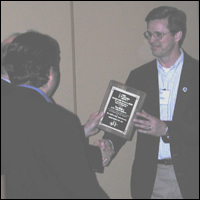 Photo: Jay Haley (right) was awarded Wind Powering America's Regional Wind Advocacy Award for the Central Region. Steve Palomo, U.S. Department of Energy Central Regional Office (front left), and Larry Flowers, Wind Powering America Technical Director (back left), presented the award.