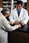 Image of an old lady talking to a pharmacist