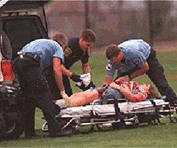 Picture of emergency medical professionals attending a bombing victim on a gurney