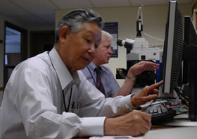 Dr. Awa in the ORISE cytogenetics lab with Dr. Livingston