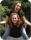 Image of a couple girls piggy back riding