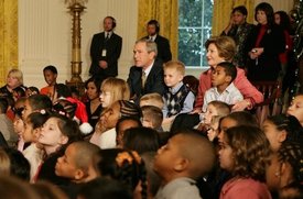 President George W. Bush and Laura Bush sit with children.