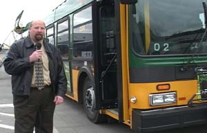 Photo:  Vehicle maintenance manager Jim Boo and a new diesel hybrid-electric bus.