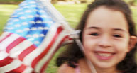 Photo of small girl waving an American Flag