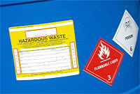 Blue disposal barrel with warning stickers