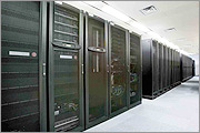 Photo showing one aisle of large racks in a data center
