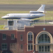 photo: small jet behind brick building