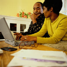 Photograph of a man and a woman looking at a computer