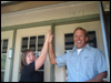 [Photo: Counselor and new homeowner high five]
