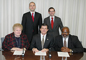 (seated left to right) BSCAI Executive Vice President, Carol A. Dean, OSHA’s then-Assistant Secretary, John Henshaw and BSCAI President, LeRoy Dock pose with BSCAI Legal Council for Government Affairs, Michael McNamara (left) and Michael Zolandz from Sonnenschein, Nath and Rosenthal LLP.