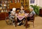 picture of 3 seniors in library, one in a wheelchair