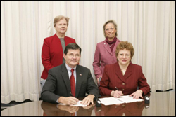 Front row L-R: OSHA’s then-Assistant Secretary, John Henshaw, and AOHP's President Emeritus, MaryAnn Gruden. Back row L-R: AOHP members, June Duck and Diane Dickerson after OSHA/AOHP national Alliance signing.