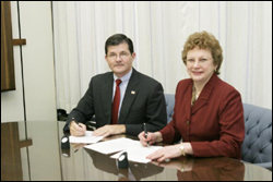 OSHA’s then-Assistant Secretary, John Henshaw, and AOHP's President Emeritus, MaryAnn Gruden, sign national Alliance February 19, 2004.