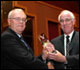 Dr. R. Bruce Tompkin Receives Bauman Award from Dr. Raymond