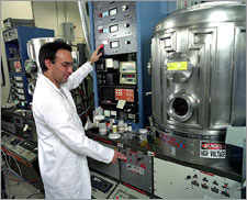 Photo of a researcher at a DOE laboratory using a physical vapor deposition system.