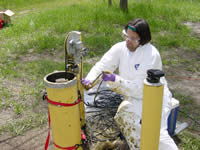 USGS scientists lowers a borehole radar antenna into a well that was used for vegetable oil injection