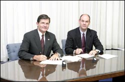 (L-R) OSHA's then-Assistant Secretary John Henshaw and Tom Hardiman, Executive Director, MBI sign national Alliance on July 28, 2004.