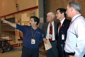 OSHA's then-Assistant Secretary, John Henshaw, taking a tour of Delta's Technical Operations Center during the VPP Seminar on June 4, 2003.