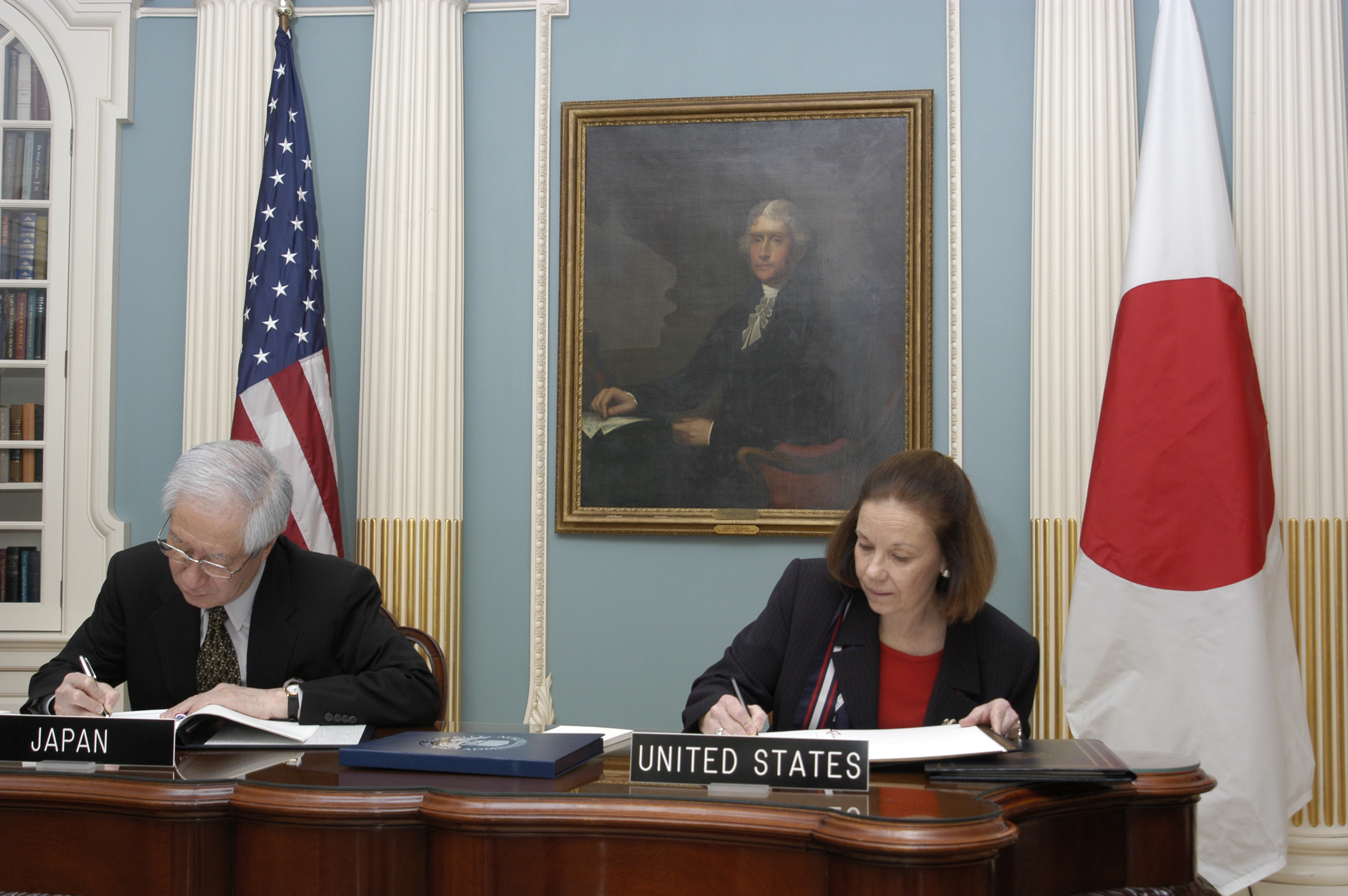 Commissioner Barnhart signs the U.S.-Japanese agreement