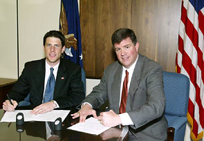 (L-R) Daniel K. Youhas, Manager, Government Affairs, SCA and OSHA's then-Acting Assistant Secretary, Jonathan L. Snare sign Alliance renewal agreement on June 16, 2005.