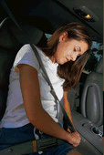 Picture of woman putting on seatbelt