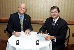 (L-R) NUCA President, William Bowman and OSHA's then-Assistant Secretary, John Henshaw sign national Alliance on December 6, 2004.