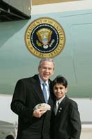 President George W. Bush presented the President’s Volunteer Service Award to Suraj Hinduja, 13, upon arrival at the airport in Columbus, Ohio, on Wednesday, February 15, 2006.  Hinduja is a volunteer at Dublin Davis Middle School and Camp Project L.E.E.D.  To thank them for making a difference in the lives of others, President Bush has met with more than 470 individuals around the country, like Hinduja, since March 2002.