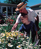 father and son in flower garden