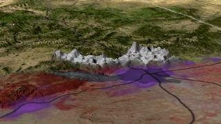 A view of the region around Denver, Colorado, on June 9, 2002, during the Hayman fire.  Both the reddish image and the 3D smoke plume are measurements from the MISR instrument on Terra.  The Hayman fire is located at the leftmost end of the smoke plume.  The regions in purple are regions of large population density, and Denver is right underneath the right end of the plume.