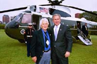 President George W. Bush met Peter Poulos upon arrival in Chicago, Illinois, on Wednesday, June 11, 2003. Poulos, a United States Army veteran, has been an active volunteer with the Retired and Senior Volunteer Program (RSVP) for 18 years. 