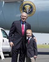 President George W. Bush presented the President’s Volunteer Service Award to Zach Bonner, 8, upon arrival at the airport in Tampa, Florida, on Thursday, September 21, 2006.  Bonner, a third-grader at Florida Virtual Academy, is creator of the Little Red Wagon Foundation Inc. and a volunteer with StandUp for Kids.  To thank them for making a difference in the lives of others, President Bush honors a local volunteer, called a USA Freedom Corps Greeter, when he travels throughout the United States.  President Bush has met with more than 500 individuals around the country, like Bonner, since March 2002.