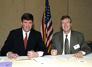 (Seated L-R) OSHA’s then-Acting Assistant Secretary, Jonathan L. Snare and John W. Mayo, PhD, Executive Director, Center for Business and Public Policy sign national Alliance agreement January 13, 2006.