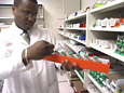 Lab Tech Examining Bottles.