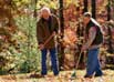 Man and grandson raking leaves