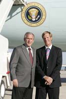 President George W. Bush presented the President’s Volunteer Service Award to John “Buzz” Garlock upon arrival at the airport in Omaha, Nebraska, on Tuesday, June 6, 2006.  Garlock is a volunteer with Girls and Boys Town.  To thank them for making a difference in the lives of others, President Bush honors a local volunteer, called a USA Freedom Corps greeter, when he travels throughout the United States.  President Bush has met with more than 500 individuals around the country, like Garlock, since March 2002.