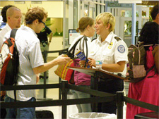 Photo of a TSO working with passengers Louis Armstrong New Orleans International Airport.