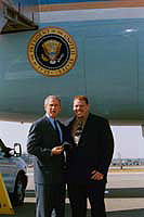 President George W. Bush met Robert Perkins upon arrival in Manchester, New Hampshire, on Thursday, October 9, 2003.  Perkins, 38, owns three Dunkin’ Donuts stores in Milford and has been an active volunteer for many years.