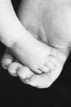 Parent holding an infant's foot