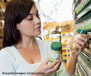 Photo:  Young adult looking at nutrition labels on products.